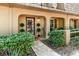 Inviting front entrance with topiaries, a decorative door, and a well-maintained walkway at 3104 Harrison Ave # E-30, Orlando, FL 32804