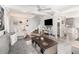 Open-concept living area with stairs to the second floor, TV, and a view of the updated kitchen at 3104 Harrison Ave # E-30, Orlando, FL 32804
