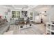 Comfortable living room with beamed ceilings, neutral decor, large windows, and access to outdoor patio at 3104 Harrison Ave # E-30, Orlando, FL 32804