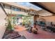 Inviting patio with brick flooring, covered seating area, a fire feature, and lush greenery for outdoor relaxation at 3104 Harrison Ave # E-30, Orlando, FL 32804
