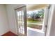 View from inside the house looking to a backyard with privacy wall and green space at 3238 Wish Ave, Kissimmee, FL 34747