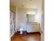 Bright bathroom featuring wood-look floors, granite vanity, and a shower and tub combination at 3238 Wish Ave, Kissimmee, FL 34747