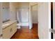 Inviting bathroom featuring a bathtub, vanity with granite countertop, and wood-style flooring at 3238 Wish Ave, Kissimmee, FL 34747