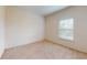 Serene bedroom with plush carpeting, bright window, and neutral tones for a relaxing ambiance at 3238 Wish Ave, Kissimmee, FL 34747