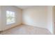 Bright bedroom featuring neutral carpet, a large window, and ample natural light at 3238 Wish Ave, Kissimmee, FL 34747