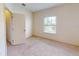 Bedroom with neutral carpeting and a window at 3238 Wish Ave, Kissimmee, FL 34747