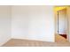 A bright bedroom with carpeted floors and an open doorway, showcasing the home's layout at 3238 Wish Ave, Kissimmee, FL 34747