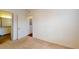 Bedroom with neutral carpeting, attached bathroom, and closet access at 3238 Wish Ave, Kissimmee, FL 34747
