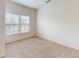 Cozy bedroom with carpeted floors, two windows offering natural light, and neutral wall paint at 3238 Wish Ave, Kissimmee, FL 34747