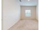 Bright bedroom featuring neutral carpeting and a window with blinds at 3238 Wish Ave, Kissimmee, FL 34747
