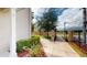 Exterior view of a walkway leading to a gated community with a privacy wall at 3238 Wish Ave, Kissimmee, FL 34747