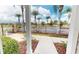 Gated community entrance with palm trees and well-maintained landscaping at 3238 Wish Ave, Kissimmee, FL 34747