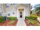 Charming townhome entrance featuring neat landscaping and a welcoming walkway at 3238 Wish Ave, Kissimmee, FL 34747