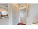 Hallway with a view into the kitchen, and a door leading to a bedroom at 3238 Wish Ave, Kissimmee, FL 34747