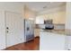 Modern kitchen featuring a breakfast bar with a stainless steel refrigerator at 3238 Wish Ave, Kissimmee, FL 34747