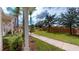 Landscaped walking path with manicured lawn and shrubbery at 3238 Wish Ave, Kissimmee, FL 34747