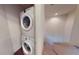 Laundry area featuring a stacked washer and dryer unit near the stairs at 3238 Wish Ave, Kissimmee, FL 34747