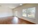 Bright living room with hardwood floors, large windows, and French doors to the backyard at 3238 Wish Ave, Kissimmee, FL 34747
