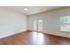 Living room featuring hardwood flooring, lots of natural light, and double doors at 3238 Wish Ave, Kissimmee, FL 34747