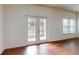 Living room featuring hard wood flooring, lots of natural light and double doors at 3238 Wish Ave, Kissimmee, FL 34747