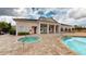 Clubhouse pool area features a spa, light brick tiling, and manicured landscaping at 3238 Wish Ave, Kissimmee, FL 34747