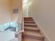 Carpeted staircase leading to the next level with views of the living space below at 3238 Wish Ave, Kissimmee, FL 34747