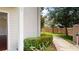 Exterior walkway with lush greenery leading to a secured community gate at 3238 Wish Ave, Kissimmee, FL 34747