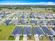 Community aerial view showing multiple homes, streets, and green spaces in the surrounding area at 408 Lily Ln, Davenport, FL 33837