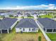 Aerial view showcasing the home's backyard, patio, and surrounding neighborhood at 408 Lily Ln, Davenport, FL 33837