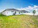 Open backyard with lawn and landscaping showcasing the house's rear elevation at 408 Lily Ln, Davenport, FL 33837