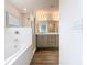A luxurious bathroom features a soaking tub and dual sink vanity at 408 Lily Ln, Davenport, FL 33837