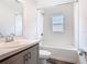 Bathroom showcasing a shower-tub combo and a vanity sink, perfect for relaxation and functionality at 408 Lily Ln, Davenport, FL 33837