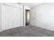 An open bedroom with a closet features neutral carpeting at 408 Lily Ln, Davenport, FL 33837