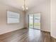 Dining area featuring wood floors, sliding glass doors to the backyard, and a modern chandelier at 408 Lily Ln, Davenport, FL 33837