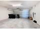 An empty two-car garage featuring an automatic door opener and space for parking and storage at 408 Lily Ln, Davenport, FL 33837