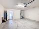 Spacious two-car garage with white walls and high ceilings, perfect for storage and parking at 408 Lily Ln, Davenport, FL 33837