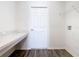 A functional laundry room with a countertop and modern wood-look floors at 408 Lily Ln, Davenport, FL 33837