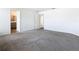Main bedroom featuring carpet flooring with ensuite bathroom and natural light, creating a peaceful retreat at 408 Lily Ln, Davenport, FL 33837