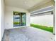 Covered patio area with sliding glass doors offers seamless indoor-outdoor living at 408 Lily Ln, Davenport, FL 33837