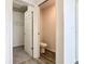 A half-bathroom including a water closet features wood-look floors at 408 Lily Ln, Davenport, FL 33837