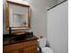 Stylish bathroom with a unique vessel sink, modern fixtures, and a shower with a white curtain at 413 Macchi Ave, Oakland, FL 34787
