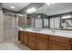 Bathroom with tile floors, a walk-in shower, and vanity with a large mirror at 413 Macchi Ave, Oakland, FL 34787