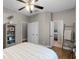 Cozy bedroom featuring hardwood floors, a comfortable bed, and convenient access to other rooms at 413 Macchi Ave, Oakland, FL 34787