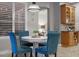 Charming breakfast nook featuring a round table, blue chairs, and bright natural light from shuttered windows at 413 Macchi Ave, Oakland, FL 34787