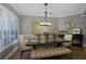 Dining room showcases a modern table, bench seating, designer lighting and a decorative mirror at 413 Macchi Ave, Oakland, FL 34787