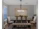 Bright dining room featuring a modern light fixture, stylish seating, and a large abstract painting at 413 Macchi Ave, Oakland, FL 34787