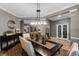 Open-concept dining space featuring a dark wood table, buffet and views into other living areas at 413 Macchi Ave, Oakland, FL 34787