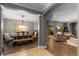 Elegant dining room with a dark wood table, decorative lighting, and an adjacent living space at 413 Macchi Ave, Oakland, FL 34787