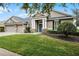 Charming single-Gathering home with well-manicured lawn and stone accents on the front columns at 413 Macchi Ave, Oakland, FL 34787