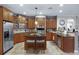 Spacious kitchen with stainless steel appliances, a center island, and ample cabinet space at 413 Macchi Ave, Oakland, FL 34787